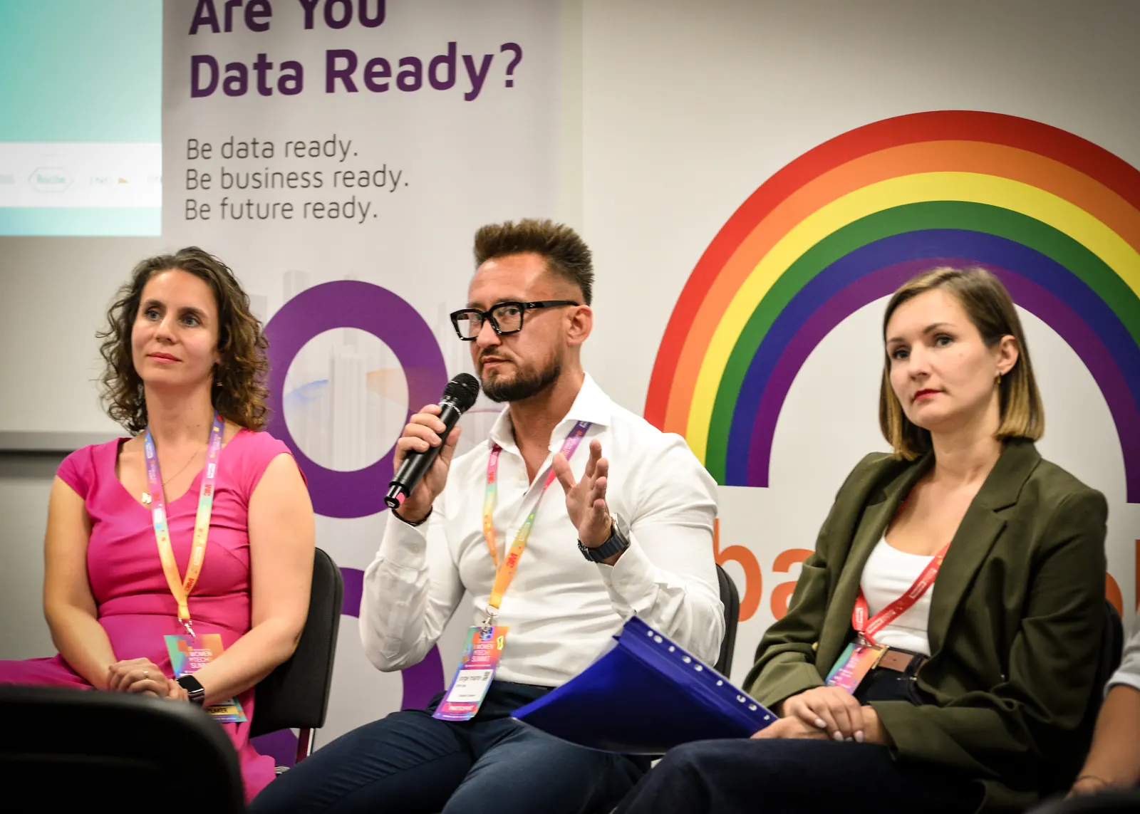 Jorge speaking into a microphone on the Women in Tech Summit panel