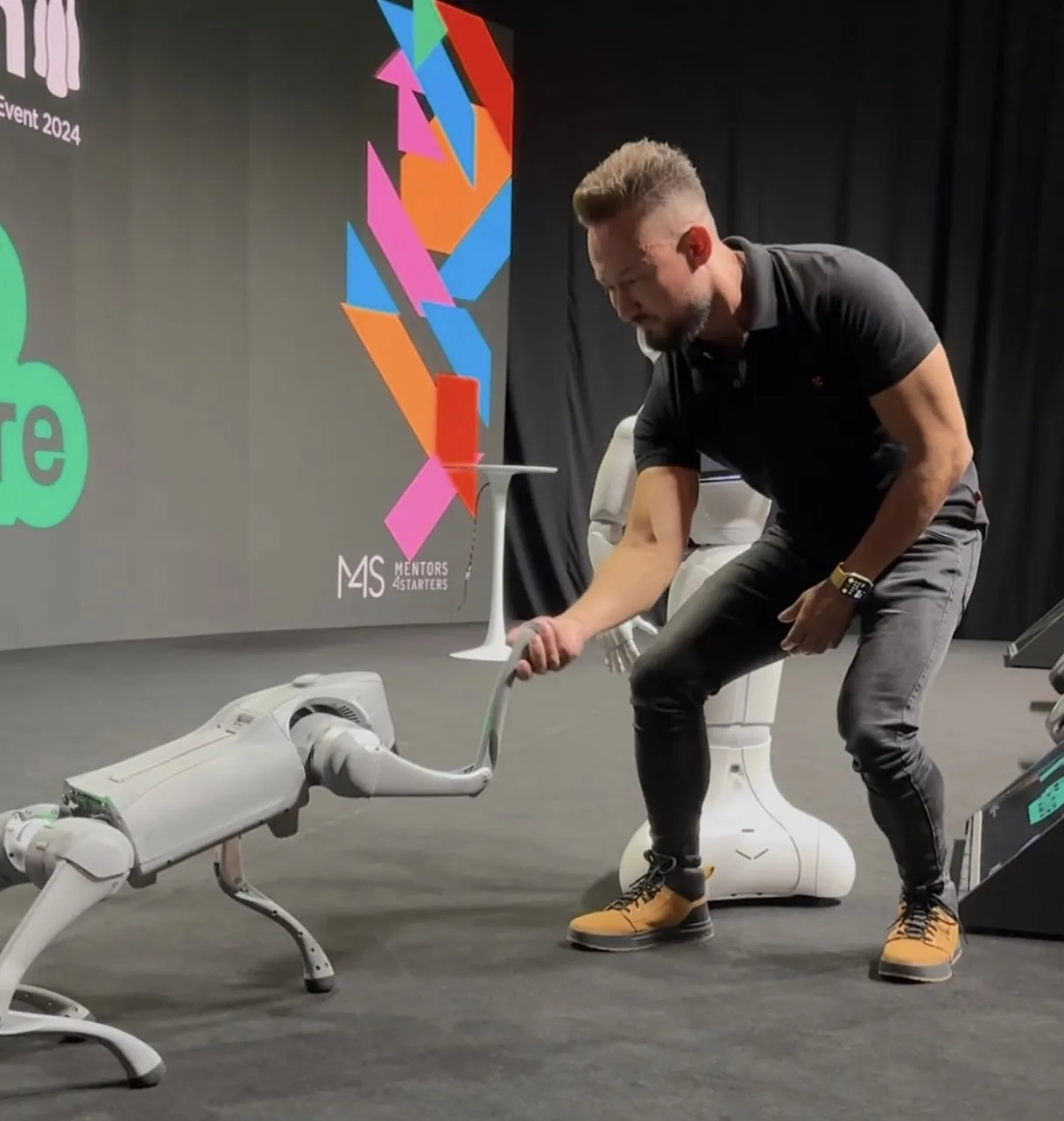 Jorge with a quadruped robot on the Skills4Future stage