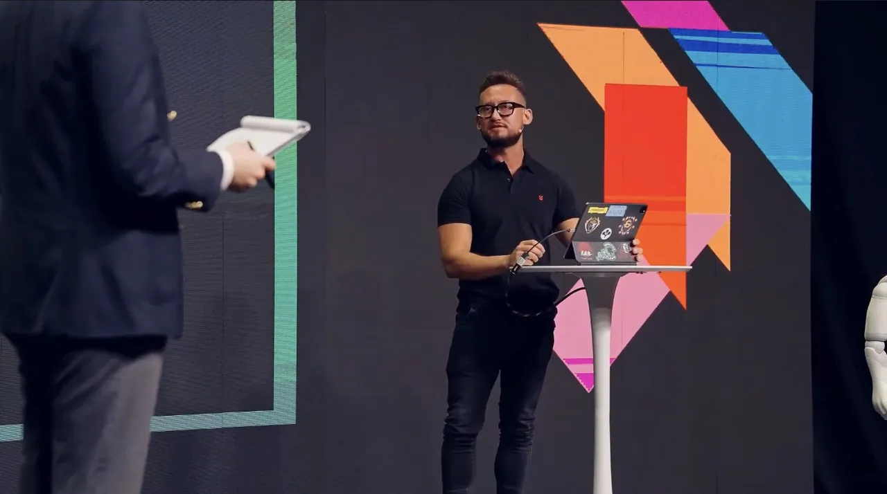 Jorge on stage at Skills4Future with a laptop, presenting